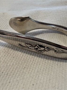 Silver 1847 Roger and bros set of six napkin clips.